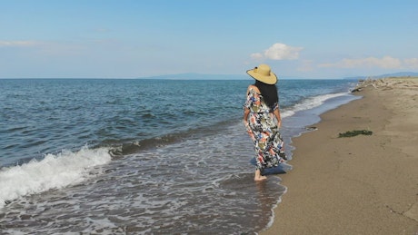 Woman walking along the sandy beach