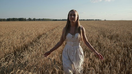 Woman walking in a wheat field