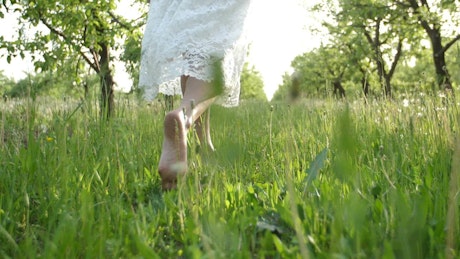 Woman walking on grass.