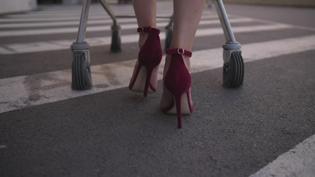 Woman walking with a shopping cart.