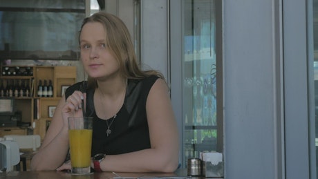 Woman with a glass of orange juice.