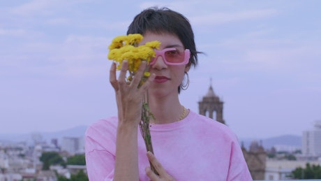 Woman with flowers and pink clothes.