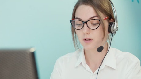 Woman with glasses doing customer support.
