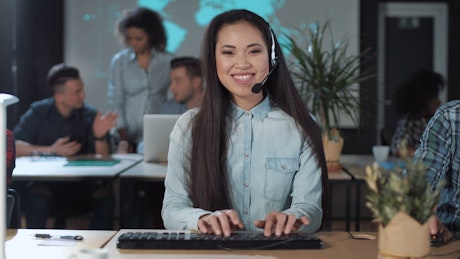Woman with headset doing customer support.