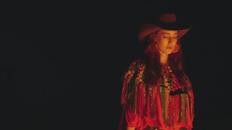 Woman with Mexican style under the light of a bonfire.
