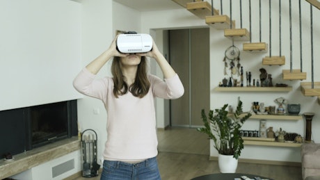 Woman working at home with VR glasses.