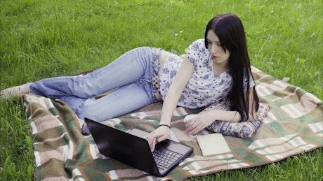 Woman working from a public park.