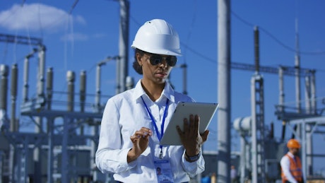 Woman working with tablet in power plant.