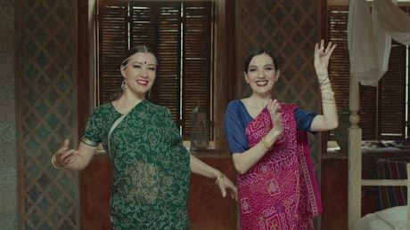 Women in a Hundu dress dancing slowly.