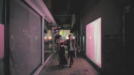 Women walking down alleyway.