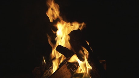 Wooden logs burning in a pit