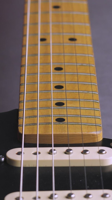Wooden neck of an electric guitar.