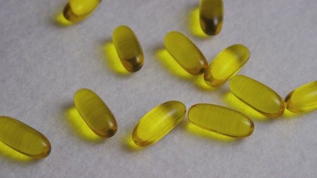 Yellow colored pills over a wide fabric.