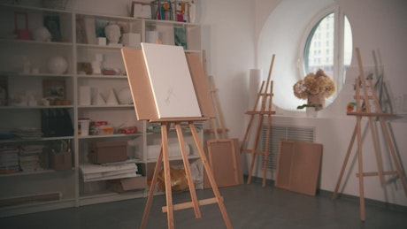 Young artist drawing on canvas at her workshop.