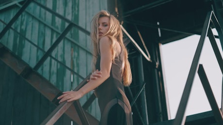 Young blonde woman in a industrial environment.