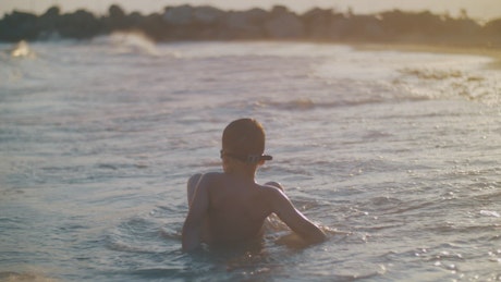 Young boy playing in the waves.