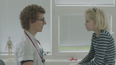 Young boy speaking to a Doctor.