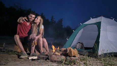Young couple enjoying a camping trip.