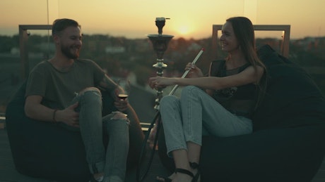 Young couple having fun in a rooftop bar.
