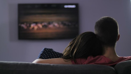 Young couple watching TV.