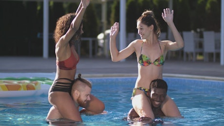 Young couples having fun at the pool