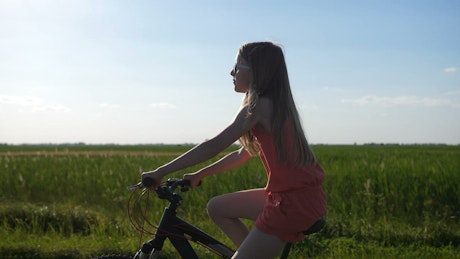 Young girl riding a bike.