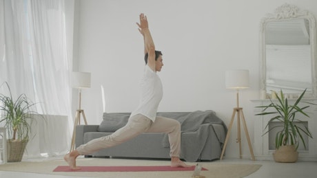 Young man practicing yoga at home