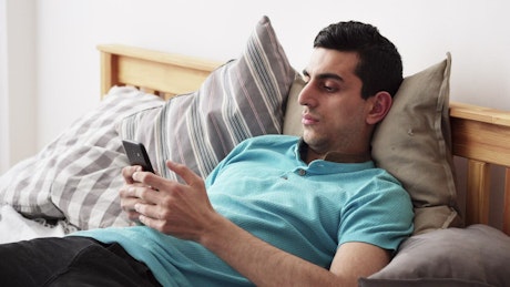 Young man relaxing with his phone
