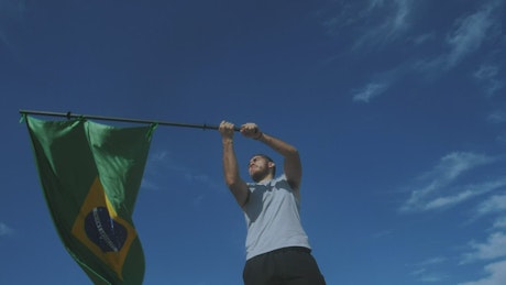 Young man waving the flag of Brazil