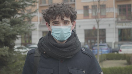 Young man with face mask on the street