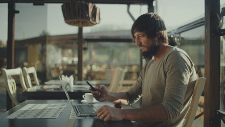 Young man working in a coffee place.