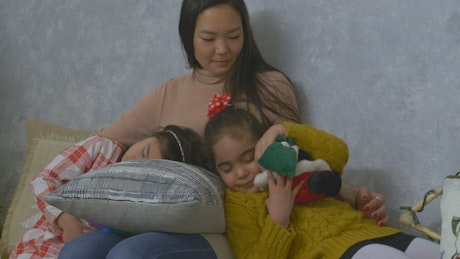 Young mother with her two daughters on christmas day