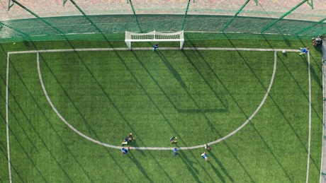Young players scoring a goal.