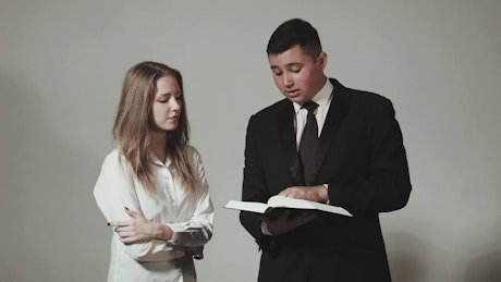 Young teens reading the bible.