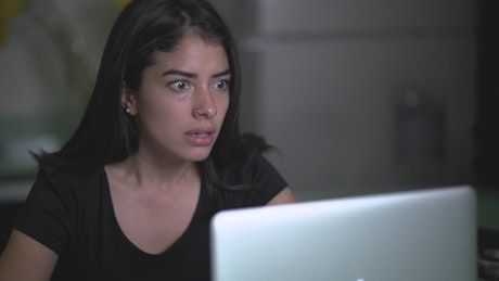 Young very frustrated woman in front of her computer.