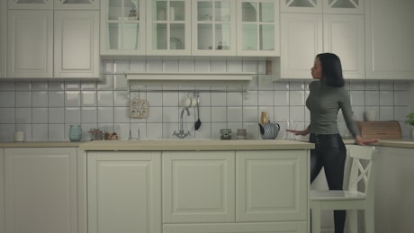Young woman dancing in the kitchen