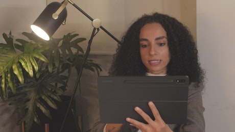 Young woman having a video call by tablet.