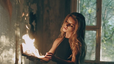 Young woman making an ancient ritual with fire.
