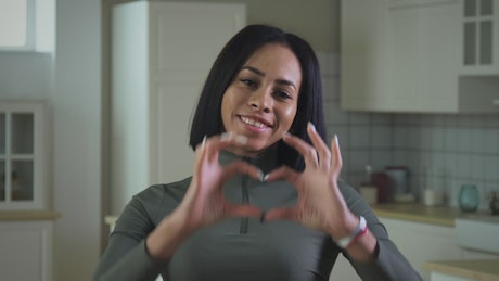 Young woman making it a heart shape with her hands