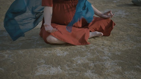 Young woman meditating sitting on the ground