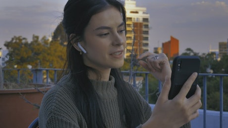 Young woman on a terrace having a video call