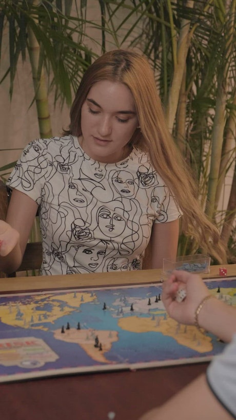 Young woman playing Risk.