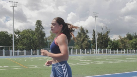Young woman running in a sports center.