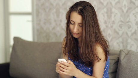 Young woman texting with her smartphone