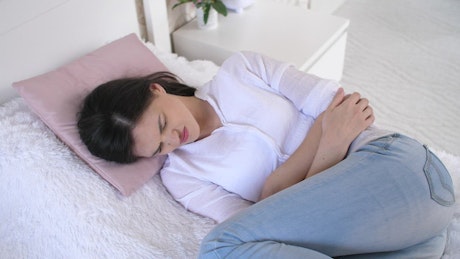 Young woman with premenstrual pain.