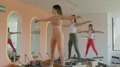 Young women doing exercise in front of the mirror.