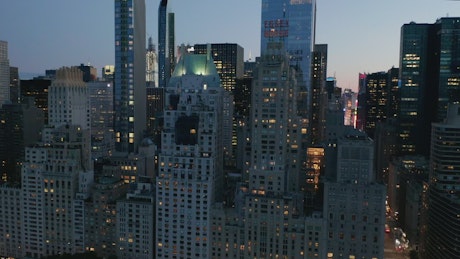 Zoom out aerial shot of Manhattan city at dusk